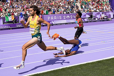 Abdihamid Nur, of the United States, falls during a heat in the men's 5000-meter round